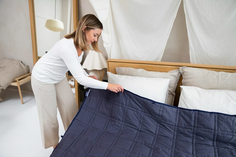 woman fixing bed